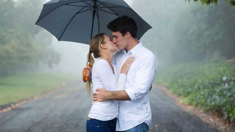 couple kissing under umbrella